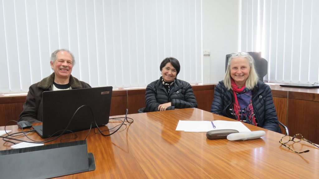 Klem Carstens handing over the Nico Carstens Digital Database to Beulah Gericke-Geldenhuys and Santie de Jongh during a meeting at the Stellenbosch University Music Library