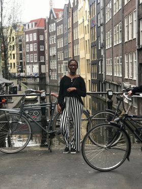 Thoko in Amsterdam in front of a canal