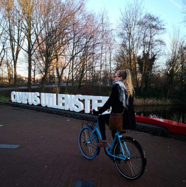 Lizanne cycling through campus