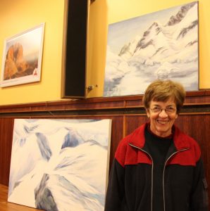 Nerine de Villiers and two of her paintings of Antarctica