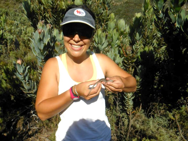 Elsje Schreuder in mountain fynbos with a Cape skink (Trachylepis capensis)