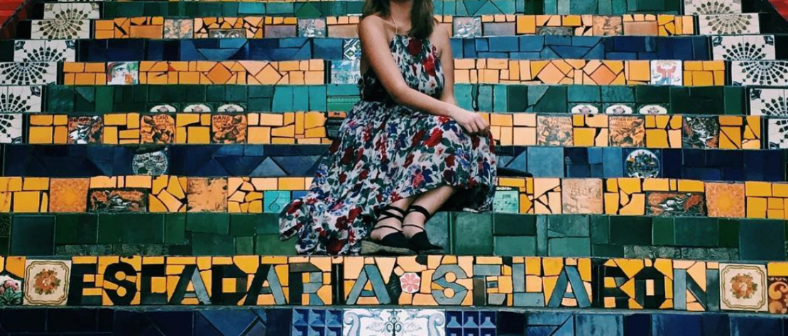Danielle sitting on the Escadaria Selarón