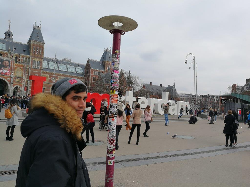 Ryan posing by the 'I am Amsterdam sign'